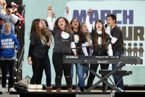 WASHINGTON, DC - MARCH 24: Marjory Stoneman Douglas High School drama club and choir members perform "Shine" during the March for Our Lives rally on March 24, 2018 in Washington, DC. Hundreds of thousands of demonstrators, including students, teachers and parents gathered in Washington for the anti-gun violence rally organized by survivors of the Marjory Stoneman Douglas High School shooting on February 14 that left 17 dead. More than 800 related events are taking place around the world to call for legislative action to address school safety and gun violence. (Photo by Chip Somodevilla/Getty Images)