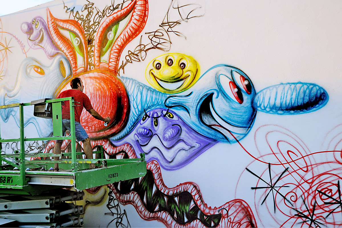 Artist Kenny Scharf creating a piece at Wynwood Walls in 2009